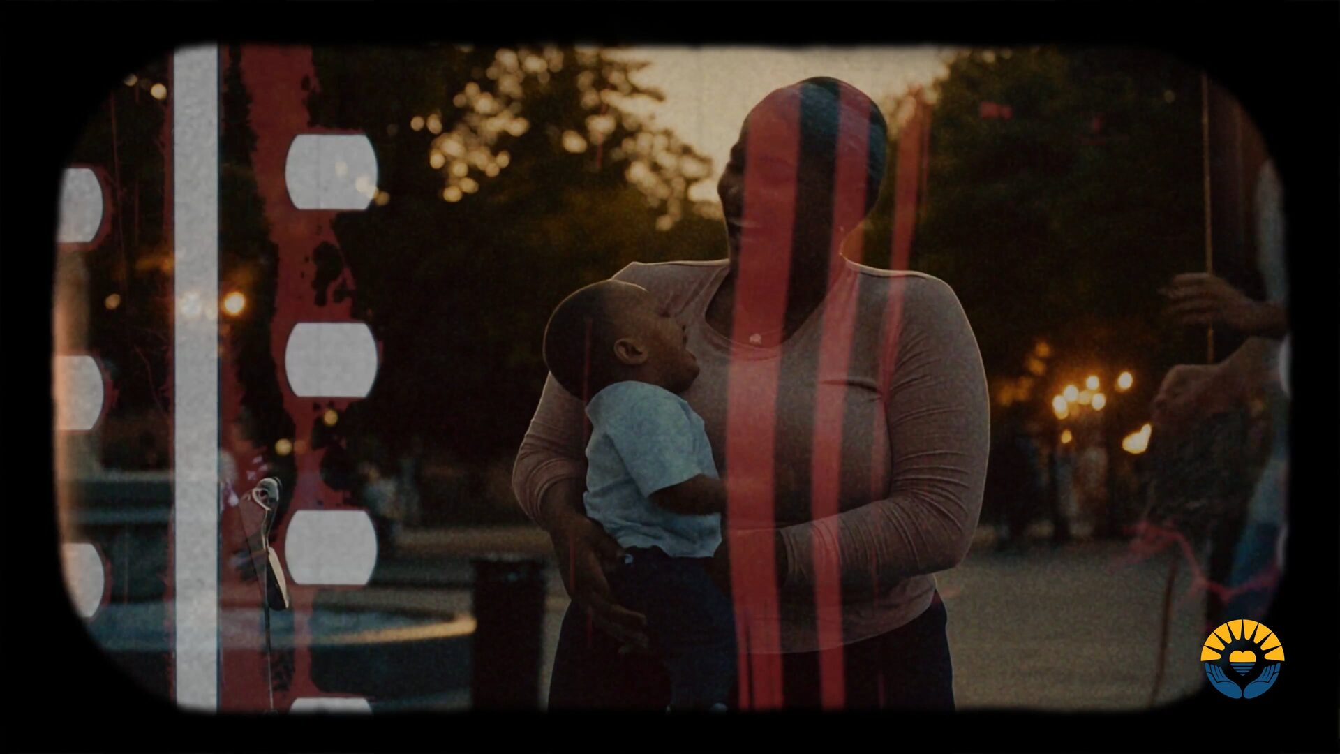AI-generated frame from "From Homeless to Housed and Hopeful": a mother holding her child at dusk, with a film-strip overlay.